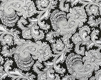 May include: Black fabric with a white paisley pattern. The fabric has a subtle sheen.