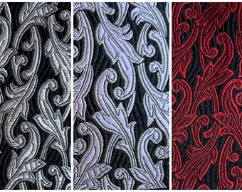 May include: Three fabric swatches with a black background and a repeating pattern of silver, lavender, and red stylized leaves.