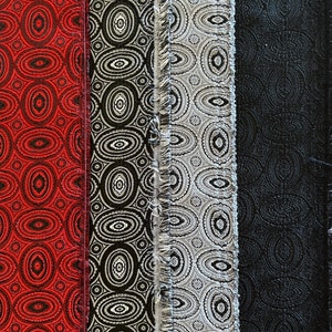 May include: Four fabric swatches with different patterns. The first swatch is red with a black and white pattern. The second swatch is black with a white and gray pattern. The third swatch is gray with a white and black pattern. The fourth swatch is black with a gray pattern.
