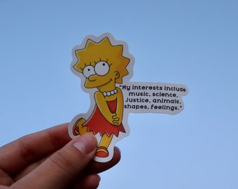 May include: A yellow cartoon character with a red dress and blonde hair. The character is holding her hands in front of her. The text "My interests include music, science, Justice, animals, shapes, feelings." is written next to the character.