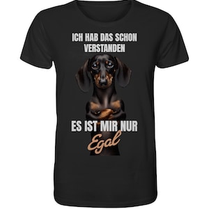 May include: Black t-shirt with a dachshund dog wearing a serious expression. The text on the shirt reads "Ich hab das schon verstanden. Es ist mir nur egal."