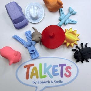 May include: A collection of colorful, small plastic toys, including a purple car, a white hat, an orange hand, a blue airplane, a red circle, a yellow sun, a black beetle, a pink pig, and a blue zipper. The word "TALKETS" is displayed.