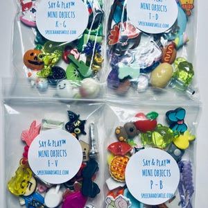 Könnte beinhalten: Vier Beutel mit bunten Mini-Objekten aus Kunststoff, die mit "Say & PlayTM Mini Objects" beschriftet sind und verschiedene Buchstabenbereiche abdecken: K-G, T-D, F-V und P-B. Jeder Beutel enthält eine Vielzahl von kleinen Spielzeugen, darunter Tiere, Lebensmittel und Alltagsgegenstände.