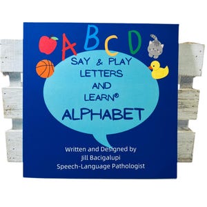 May include: A blue book with the letters ABCD in a speech bubble. The book title is "Say & Play Letters and Learn Alphabet". The book is written and designed by Jill Bacigalupi, Speech-Language Pathologist.