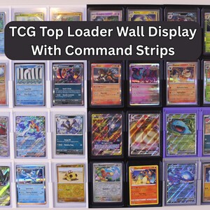 May include: A wall display for TCG top loaders with command strips. The display is white with black and purple frames, holding various trading cards. The cards feature colorful illustrations and text.
