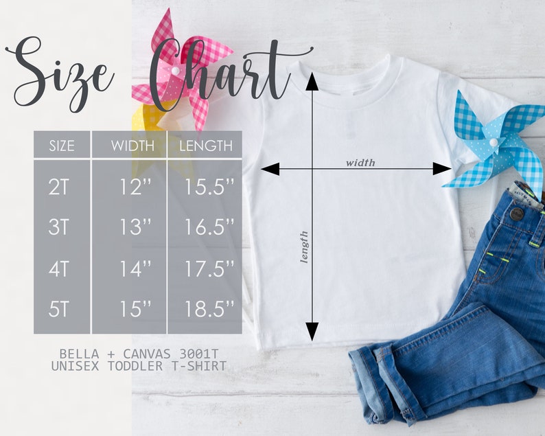 May include: White unisex toddler t-shirt with a size chart. The chart shows measurements for sizes 2T to 5T, with widths from 12" to 15" and lengths from 15.5" to 18.5". The shirt is paired with blue jeans and decorative pinwheels.