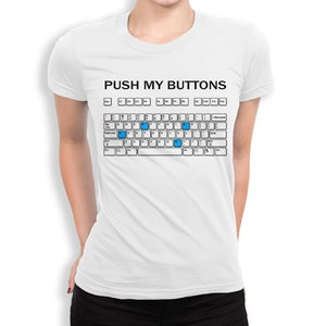 May include: White t-shirt featuring a keyboard graphic with the text "PUSH MY BUTTONS" above it. The keyboard keys are white with black lettering, and some keys are highlighted in blue.
