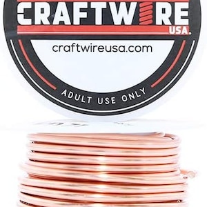 May include: A spool of copper wire, 20 gauge, for crafting. The wire is wound tightly and is a shiny copper color. The spool is labeled "Craftwire USA" and "craftwireusa.com".