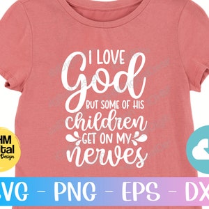May include: A pink t-shirt with white text that reads "I love God but some of his children get on my nerves".