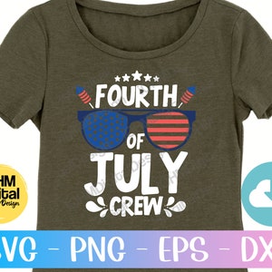 May include: A green t-shirt featuring the text "FOURTH OF JULY CREW" in white lettering. The text is surrounded by red, white and blue stars and fireworks. The text "FOURTH" is in a larger font than the rest of the text. The text "OF" is in a smaller font than the rest of the text. The text "JULY" is in a larger font than the rest of the text. The text "CREW" is in a smaller font than the rest of the text.