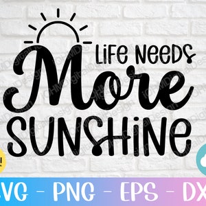 May include: Black and white graphic design with a sun and the text "Life Needs More Sunshine".