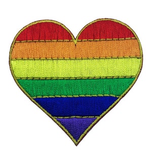 Op de afbeelding: Geborduurde hartvormige patch met een regenboogontwerp. De patch heeft rode, oranje, gele, groene, blauwe en paarse strepen en een gouden rand. Geschikt voor kleding of accessoires.