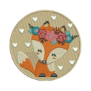 May include: Embroidered patch of a cartoon fox with an orange body, white details, and a floral crown. The fox is on a beige circle with white heart accents. The patch has a stitched border.