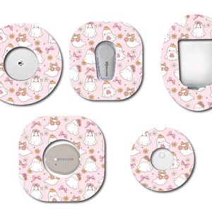May include: A collection of pink adhesive patches with a repeating pattern of white cartoon ghosts wearing flower crowns and bows. The patches are in various shapes and sizes, designed to fit medical devices. The patches have cutouts for device components.