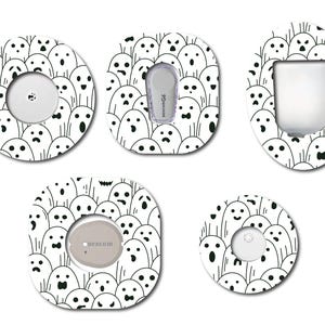 May include: Five different designs of round and oval shaped adhesive stickers with a white background and black outlines of cartoon ghosts with different facial expressions. The stickers are designed to cover medical devices.