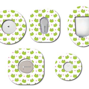 May include: Five different designs of round and square adhesive stickers with a frog and heart pattern. The stickers are designed to cover medical devices.