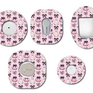 May include: A collection of pink, patterned adhesive patches featuring a Halloween theme. The designs include ghosts, pumpkins, and bows. The patches are in various shapes, including circles, squares, and ovals, with cutouts for medical devices.
