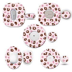 May include: A selection of pink and brown leopard print medical device covers and accessories. The set includes various shapes and sizes, such as round, oval, and rectangular, with a repeating pattern of brown and pink spots. Some pieces have openings for device components.