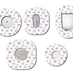 May include: Five different designs of adhesive medical device covers featuring a watercolour floral pattern with pink and purple flowers on a white background. The designs include a round cover, a square cover, and three different oval covers.
