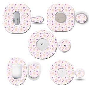 May include: A collection of medical device stickers with a repeating pattern of colorful hearts and small flowers on a light pink background. The stickers are in various shapes and sizes, designed to fit different devices.