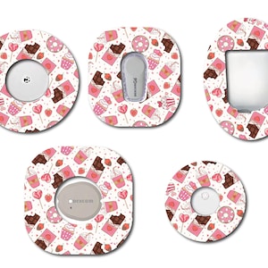 May include: A collection of patterned adhesive patches for medical devices. The designs feature a repeating pattern of pink cupcakes, chocolate bars, donuts, and hearts on a white background. The patches have various shapes to fit different devices.