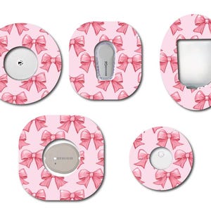 May include: Five pink and white patterned adhesive stickers for a medical device. The stickers feature a pink bow pattern on a white background. The stickers are designed to cover the device and add a personal touch.