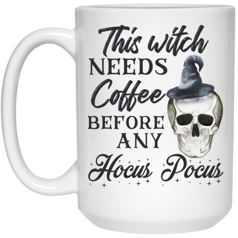 May include: White ceramic coffee mug with a black handle. The mug features the text "This witch NEEDS Coffee BEFORE ANY Hocus Pocus" in a whimsical font, along with a skull wearing a witch hat.
