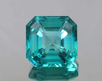 May include: A vibrant green gemstone with a square emerald cut. The gemstone is faceted and has a high degree of brilliance.