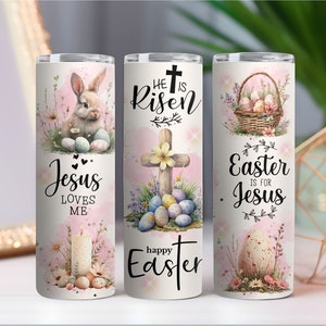 May include: Three white stainless steel tumblers with Easter-themed designs. One features a bunny and the text "Jesus Loves Me." Another has a cross and the words "He is Risen" and "Happy Easter." The third shows a basket of eggs and the text "Easter is for Jesus."