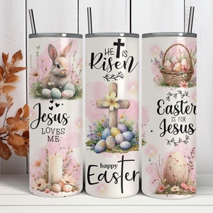 May include: A set of three stainless steel insulated tumblers with black straws. Each tumbler features an Easter-themed design with a bunny, cross, and Easter eggs. The text includes "Jesus Loves Me", "He is Risen", and "Easter is for Jesus".