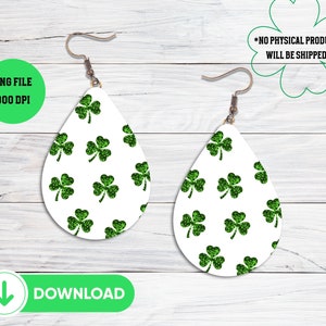 May include: A pair of white teardrop-shaped earrings with a green glitter shamrock pattern. The earrings are 300 DPI and are available as a digital download.