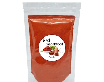 May include: A clear plastic bag filled with red sandalwood powder. The bag has a white label with the text "Red Sandalwood Powder" and a picture of sandalwood sticks and powder.