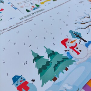 May include: A white sheet of paper with a number search game for children. The game features a winter scene with a snowman, pine trees, and numbers from 0 to 12. The text on the sheet reads "Zahlen suche im Schnee Wald" which translates to "Number search in the snow forest".