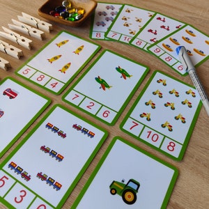May include: A set of 10 colorful flash cards with various images of vehicles and numbers. The cards are designed to help children learn to count and identify different types of vehicles.