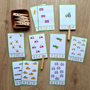 May include: A set of ten printable counting cards featuring various vehicles, including cars, trucks, airplanes, and motorcycles. Each card has a number and a corresponding number of vehicles. The cards are designed for children to learn counting and number recognition.