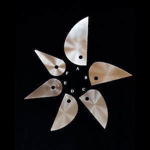 May include: Six stainless steel pastry tools with different shapes and sizes. Each tool has a hole in the center and is labeled with a letter from A to F.