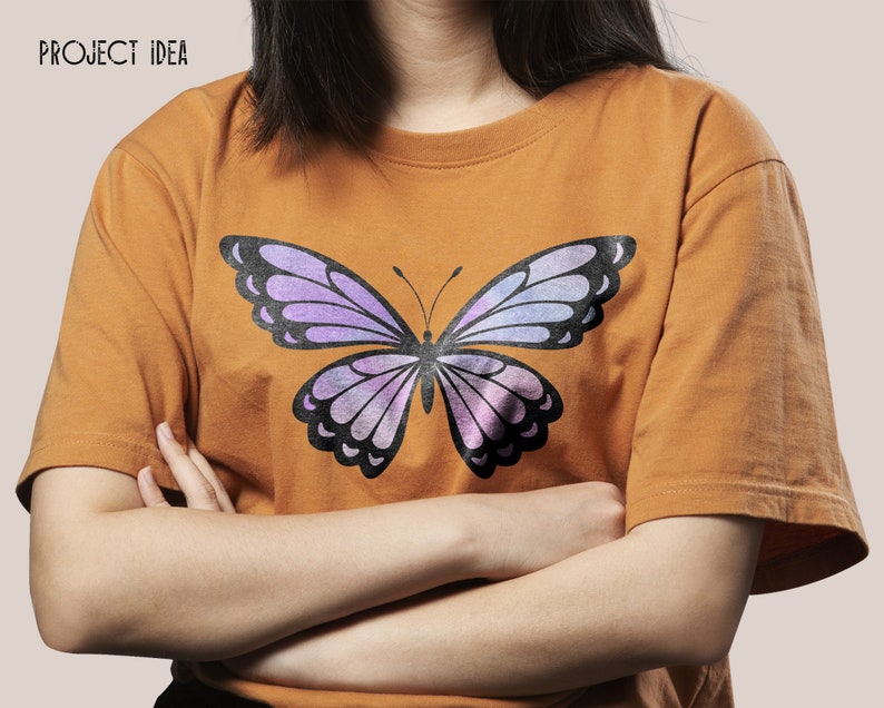 May include: A mustard yellow t-shirt with a purple and black butterfly graphic print.