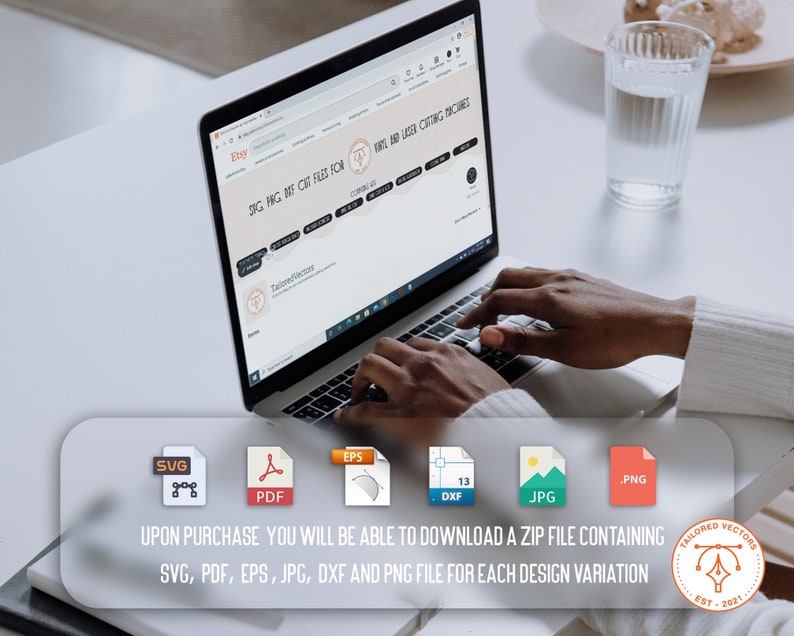 May include: A laptop computer with a web browser open to a website selling digital cut files for crafting machines. The website is called "Tailored Vectors" and the text "SVG, PNG, DXF, CUT FILES FOR VINYL AND LASER CUTTING MACHINES" is displayed on the screen. The website also features a logo with the text "Tailored Vectors" and the year "EST. 2021".