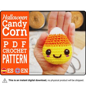 May include: A crochet candy corn pattern in PDF format. The pattern is available in both English and Spanish. The image shows a crocheted candy corn with a smiling face.