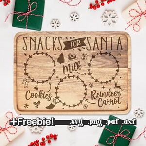 May include: A wooden cutting board with a Christmas theme. It has the text "Snacks for Santa" and three circles with the words "Cookies", "Milk", and "Reindeer Carrot".