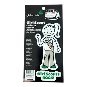 May include: A black and white sticker featuring a stick figure of a Girl Scout wearing a sash with badges. The sticker says "Girl Scout Cadette Senior Ambassador Car Sticker" and "Girl Scouts ROCK!"