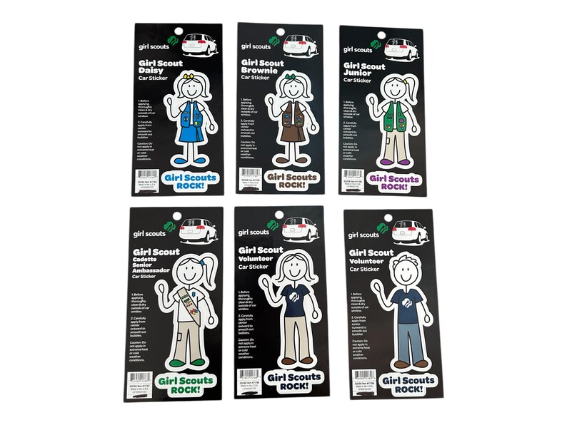 May include: Set of ten Girl Scout car stickers featuring a stick figure of a girl in different Girl Scout uniform colors. Each sticker has the words "Girl Scouts Rock!" printed on it.