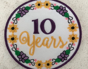 Écusson bénévole, cheffe d'équipe, cadette junior, ambassadrice senior, 10 ans d'utilisation