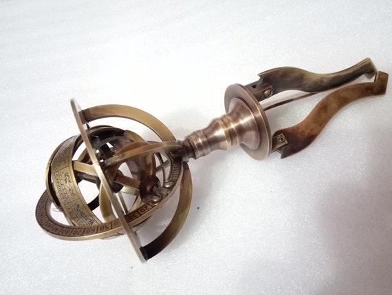 Brass rotating armillary globe with brass tripod stand