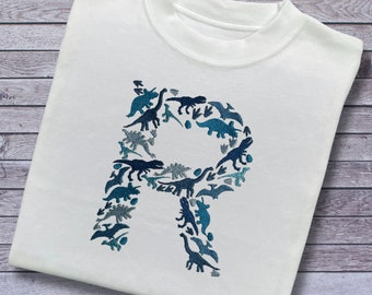 Personalised Embroidered Childrens Dinosaur Top. Dinosaurs in Beautiful Shades of Blue Make Up the Letter. A Perfect Gift for Dinosaur Fans.