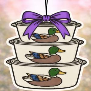 May include: A set of three ceramic mugs with a speckled, matte finish. The mugs are in shades of cream, gray, and black. Each mug has a simple, modern design, perfect for coffee or tea. The mugs are stacked on top of each other.