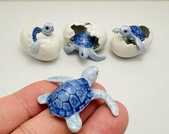 Statuetta in ceramica di tartaruga marina, blu e bianca, in fase di schiusa, miniatura oceanica dipinta a mano