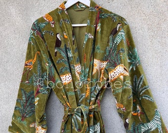 May include: A green velvet robe with a jungle print featuring toucans, leopards, and palm trees. The robe has a self-tie belt.
