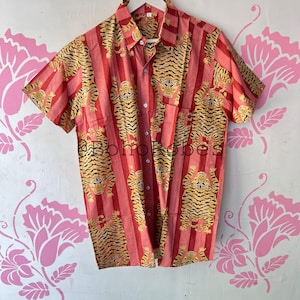 May include: A red and yellow short-sleeved button-up shirt with a tiger print pattern.
