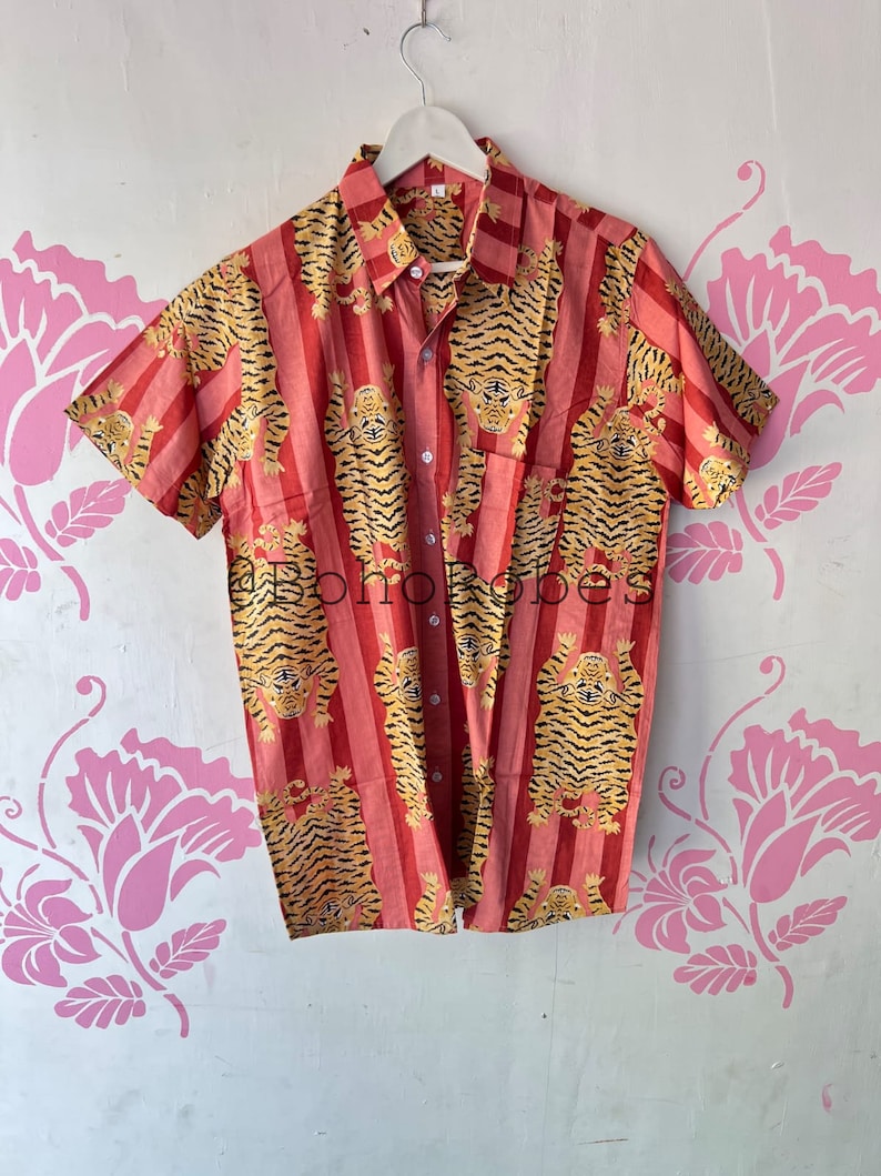 May include: A red and yellow short-sleeved button-up shirt with a tiger print pattern.